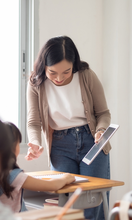 Educator showing a student something on a tablet