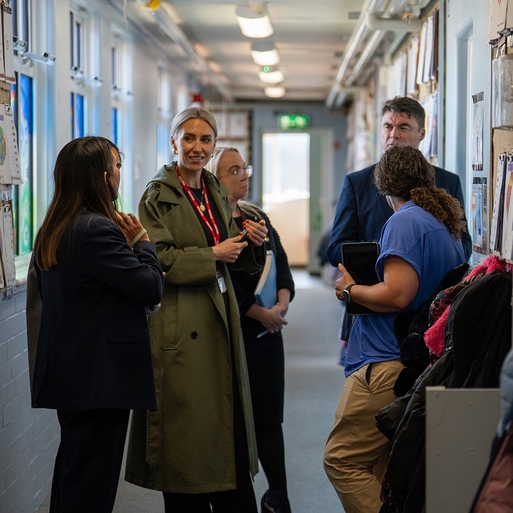 Educators talking in a hallway