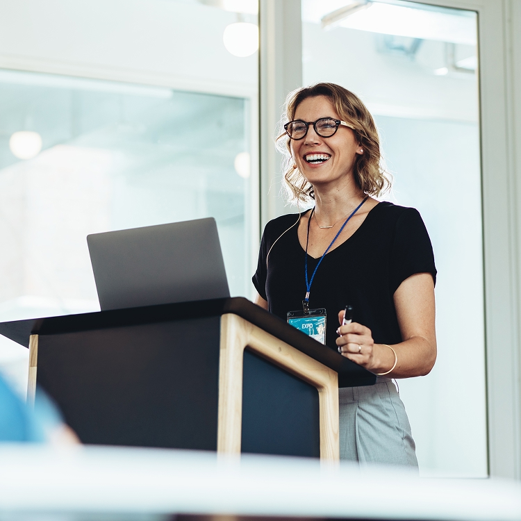 Professional educator speaking at a conference